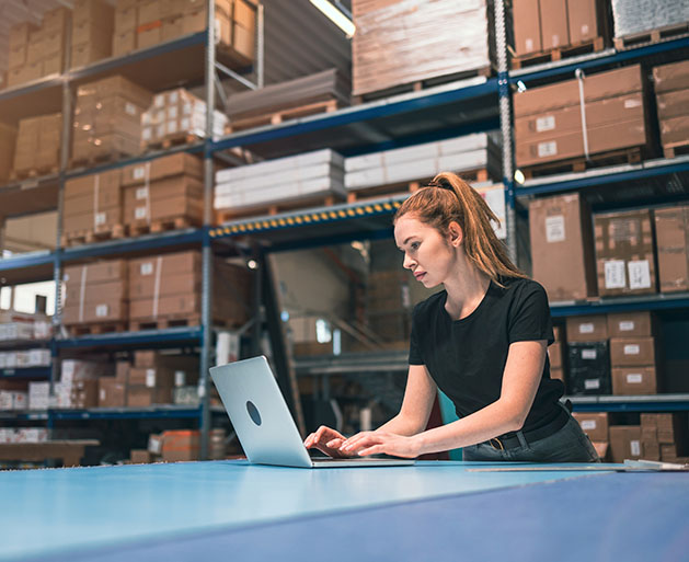 A warehouse worker using GeminiPay's POS inventory management systems