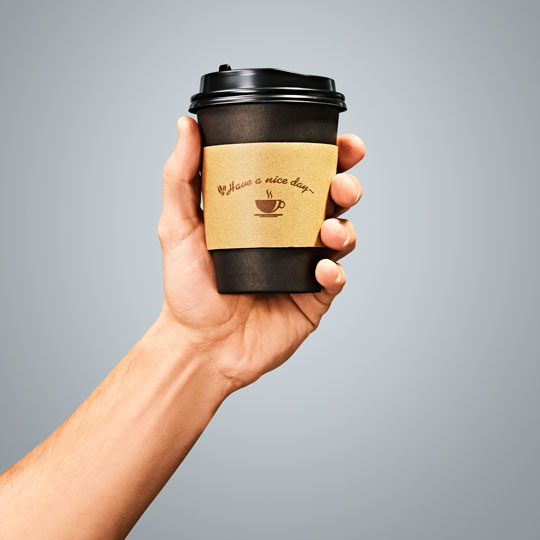 A hand holding a cheese burger