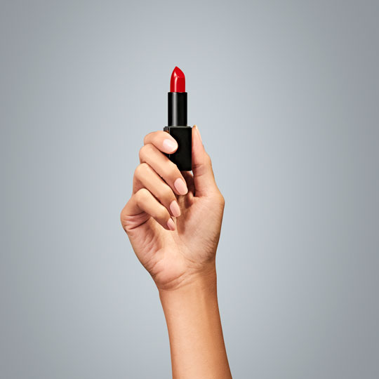 A hand holding a debit card