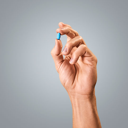A hand holding a debit card