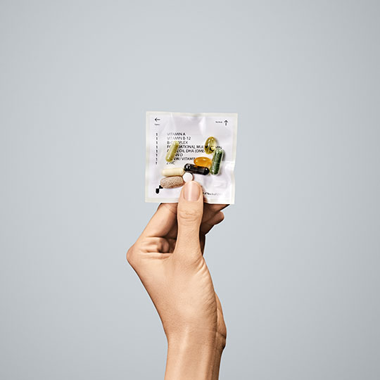 A hand holding a pills packet